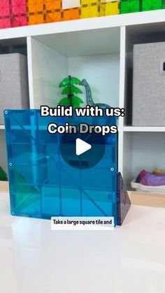 a video demonstrating how to build with us coin drops in an office cubicle filled with colorful bins