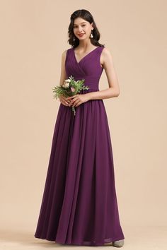 a woman in a long purple dress holding flowers