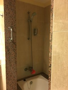 a bathroom with a bathtub, shower head and hand held faucet in it