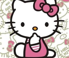 hello kitty sitting on the ground with her hand up to her mouth, saying hello kitty