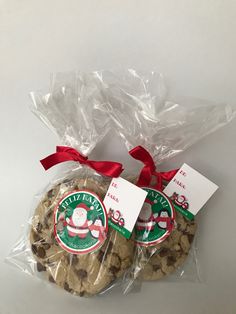 two cookies wrapped in plastic and tied with red ribbon