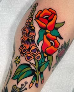 a close up of a person's arm with flowers on it