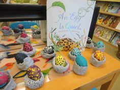 there are many colorful eggs on display in the store with a sign that says an egg is quiet