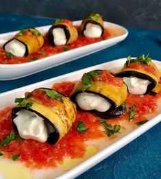 two white plates filled with food on top of a blue table