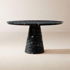 a black marble table sitting on top of a white floor