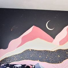 there is a painting on the wall that looks like mountains and stars in the sky