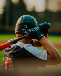 a baseball player holding a bat on top of a field