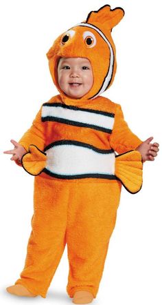 a baby dressed in an orange clown fish costume standing with his hands on his hips