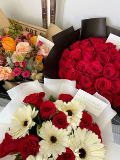 red roses and white daisies arranged in a heart - shaped arrangement for valentine's day