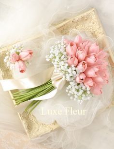 a bouquet of pink tulips and baby's breath