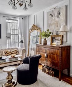 a living room filled with furniture and a mirror