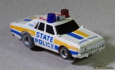 a toy police car is shown on the floor