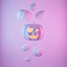 a purple and blue pumpkin floating in the air