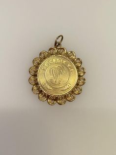 Vintage 14k yellow gold St. Croix charm. The charm weighs 3 grams of gold. 14k Gold Coin Jewelry Stamped 14k, Yellow Gold Medallion Charm Jewelry, Yellow Gold Medallion Jewelry With Charms, Gold Round Jewelry With Logo Charm, Yellow Gold Vintage Charms As Gifts, Collectible Yellow Gold Amulet Jewelry, 14k Gold Vintage Charm Round Pendant, Vintage Yellow Gold Charms For Gifts, Vintage Yellow Gold Charms For Gift