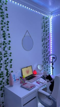 a laptop computer sitting on top of a white desk