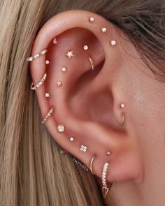 a woman's ear with three different types of piercings