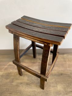 a wooden bench sitting on top of a hard wood floor