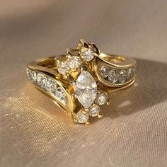 two gold rings with white diamonds on them