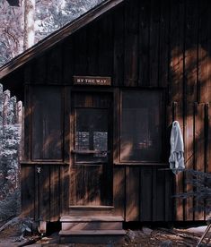 an old wooden building in the woods