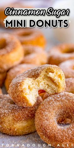 cinnamon sugar mini doughnuts stacked on top of each other with the bite taken out