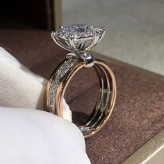 a close up of a diamond ring on a cloth