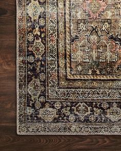 an area rug with brown, beige and blue colors on the floor in front of a wooden