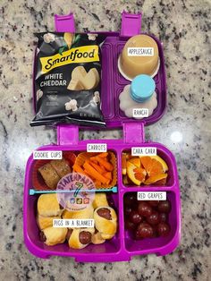 two plastic containers filled with food on top of a counter