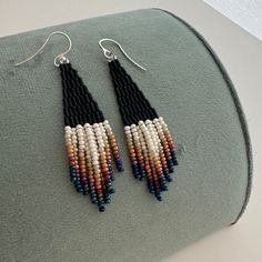 These matte black beaded earrings with ombre ivory fringe are made of high quality Japaneze and Czech beads. They are lightweight and comfortable. These beaded earrings are an amazing gift for special occasions: holidays, birthdays, anniversaries, Christmas, Valentine's Days and more.  This pair is a mix of ethnicity and modern casual style. I create for women who love to feel completely different. -------------------------------------------- ✦ The Details: ✔ Made with quality Czech beads ✔ Made Boho Fringe Earrings, Handwoven Black Beaded Dangle Earrings, Black Tassel Earrings With Dangling Beads For Festival, Black Beaded Fringe Tassel Earrings For Festival, Elegant Handwoven Black Beaded Earrings, Elegant Black Handwoven Beaded Earrings, Black Beaded Tassel Earrings For Festivals, Bohemian Black Tassel Earrings With Dangling Beads, Black Bohemian Dangle Tassel Earrings