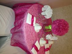 the table is set with pink and white decorations