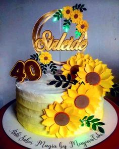 a birthday cake with sunflowers and the number 40 on top is decorated in gold