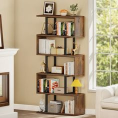 a living room filled with furniture and a book shelf next to a fireplace in front of a window