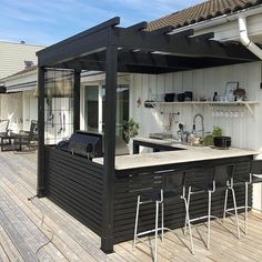 an outdoor kitchen and bar on a deck