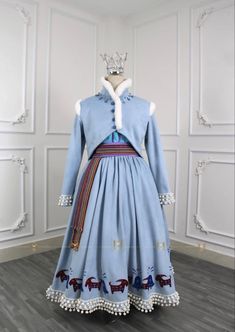 a blue dress with horses on it and a crown