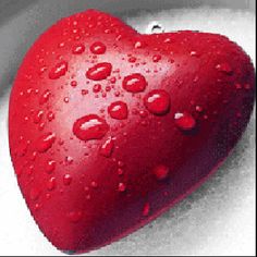 a heart shaped object with water droplets on it