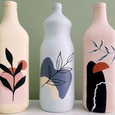 three painted bottles sitting next to each other