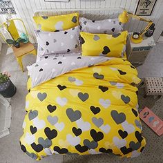 a bed with yellow and black hearts on it