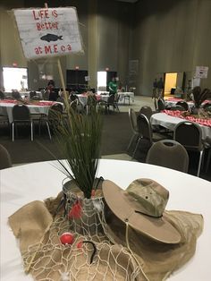 a hat and other items are sitting on a table in a room with many tables