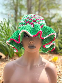 a mannequin wearing a green and pink hat