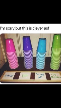 there are many different colored cups on the counter top, and one is saying i'm sorry but this is clever asf