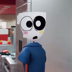 an odd looking robot is standing in the kitchen