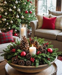 a christmas centerpiece with pine cones and candles