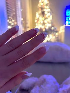 white french tip nails with cute bow accents French Almond Nails Design White, Christmas Nail Ideas French Tips, Simple French Tip Christmas Nails, White French Tip With Christmas Design, White French Christmas Nails, French Tips For Christmas, Christmas French Tip Nails Almond, Red And White Christmas Nails French Tips, White French Tips With Mistletoe