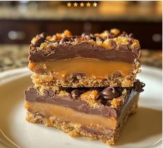 two pieces of chocolate peanut butter bars stacked on top of each other