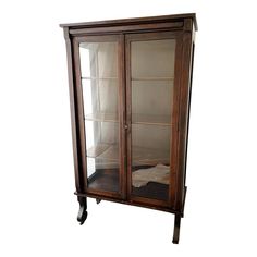 an antique display cabinet with glass doors