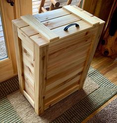 a wooden box sitting on top of a rug in front of a door with a handle