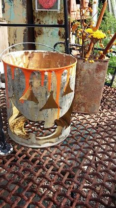 an old metal bucket sitting on top of a table