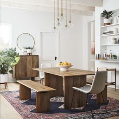 a dining room table with two benches in front of it