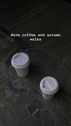 two coffee cups sitting next to each other on top of a stone slab with the caption warm coffee and autumn walks