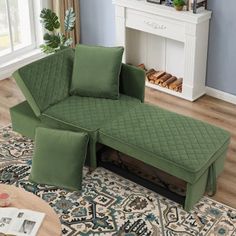 a green couch sitting on top of a rug in a living room