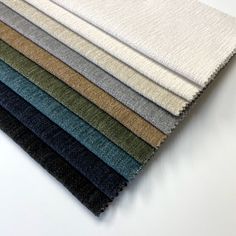 several colors of fabric laid out on top of each other, all in different sizes